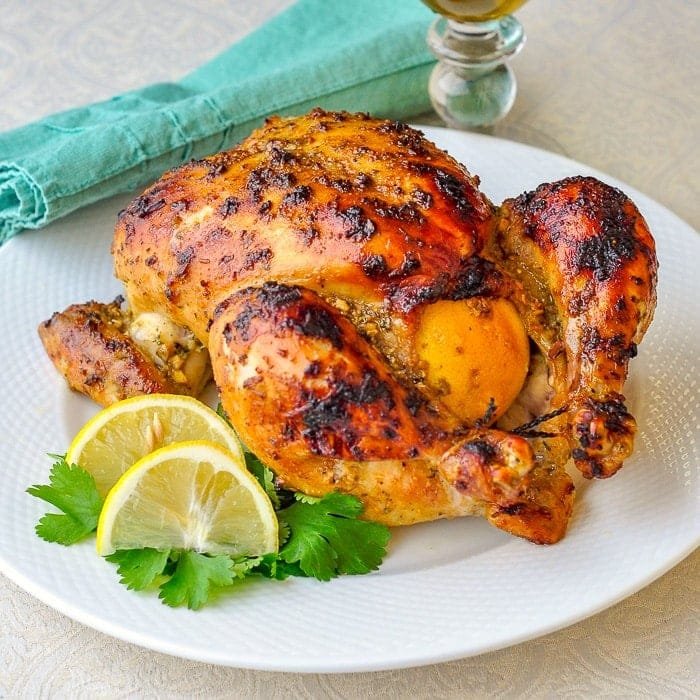How to Make the Best Dijon Roasted Lemon Chicken Dijon Roasted Lemon Chicken photo of whole roasted chicken on a white plate with lemon and parsley garnish
